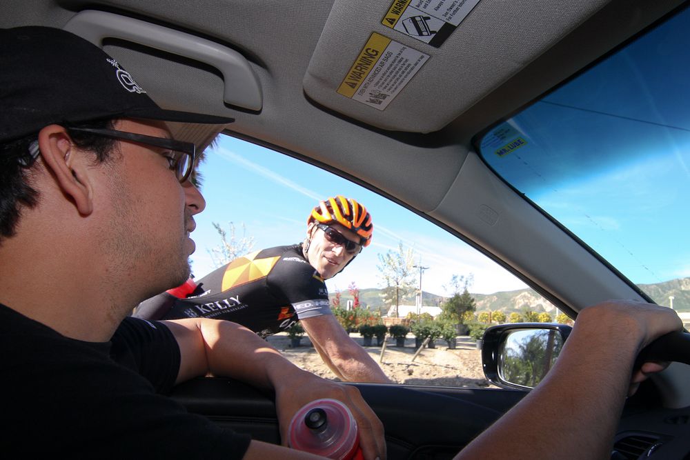 Mechanic Erik Maresjo hands Brad Huff some water.