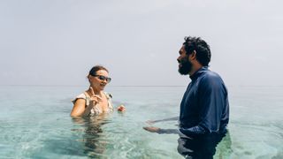 woman and man in water talking about turtles