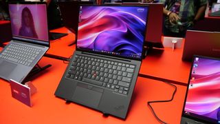 Images of the Lenovo ThinkPad X1 Carbon Gen 13 Aura Edition on a red table at IFA 2024