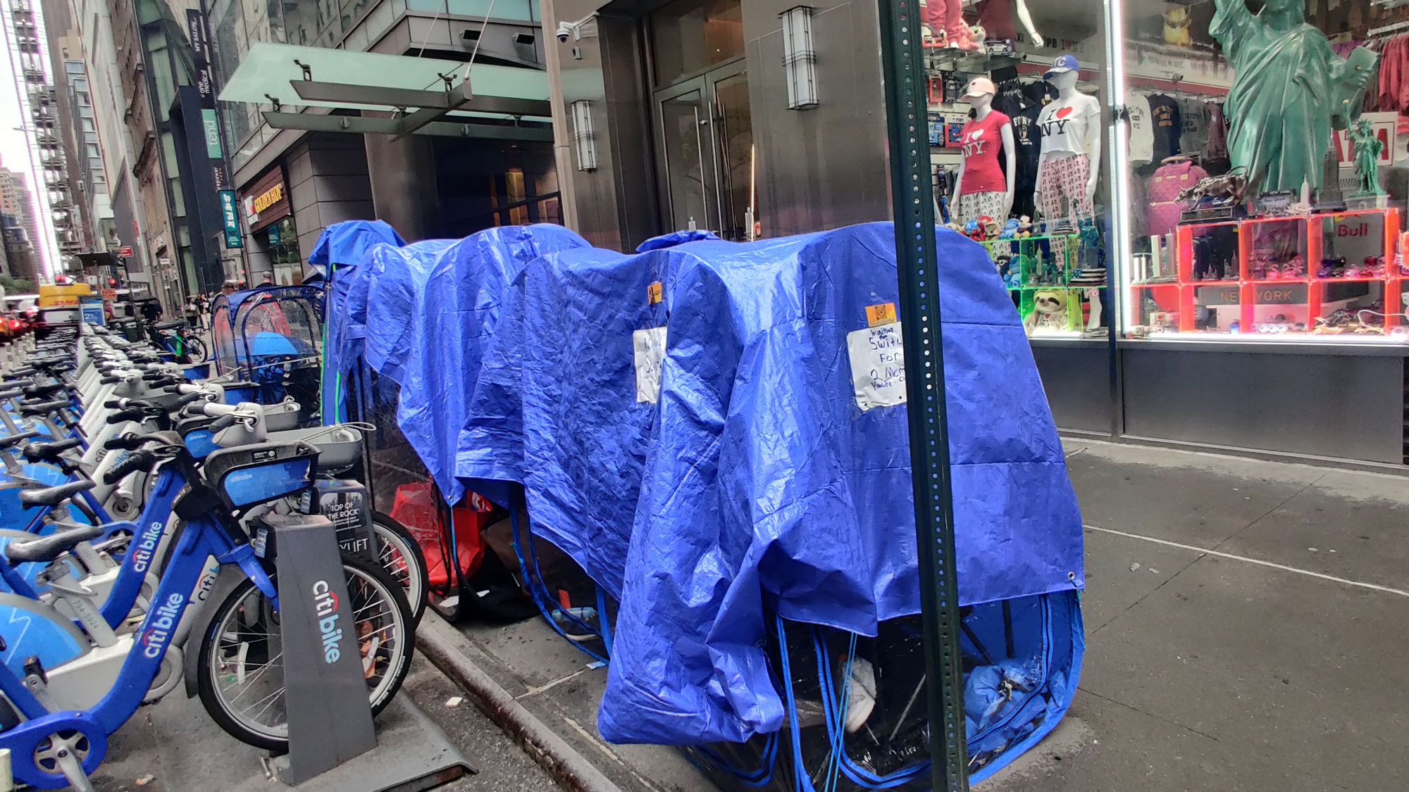 Blue tarps hang over chairs outside the Nintendo store in Manhattan in the spring of 2025.