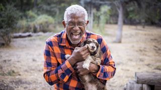 Senior man laughing with dachshund