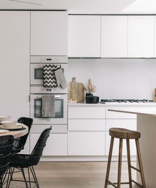 Modern white kitchen with handleless cabinets