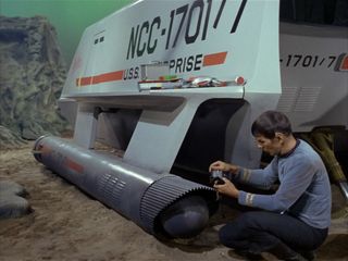 Spock (Leonard Nimoy) surveys damage from Galileo’s crash landing on planet Taurus II (episode “The Galileo Seven”)