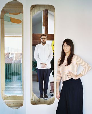 Stefan von Bartha (behind) and his wife, Hester Koper inside their art-studded apartment