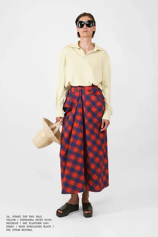 model wearing plaid skirt and yellow shirt