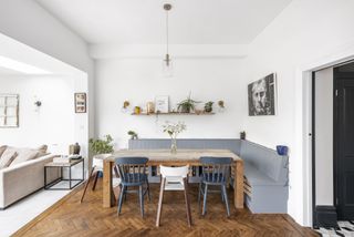 light blue bench seating with wooden dining table in white extension