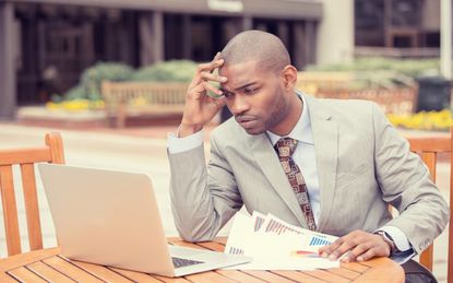 Busy man analyzing company financial report balance sheet statement