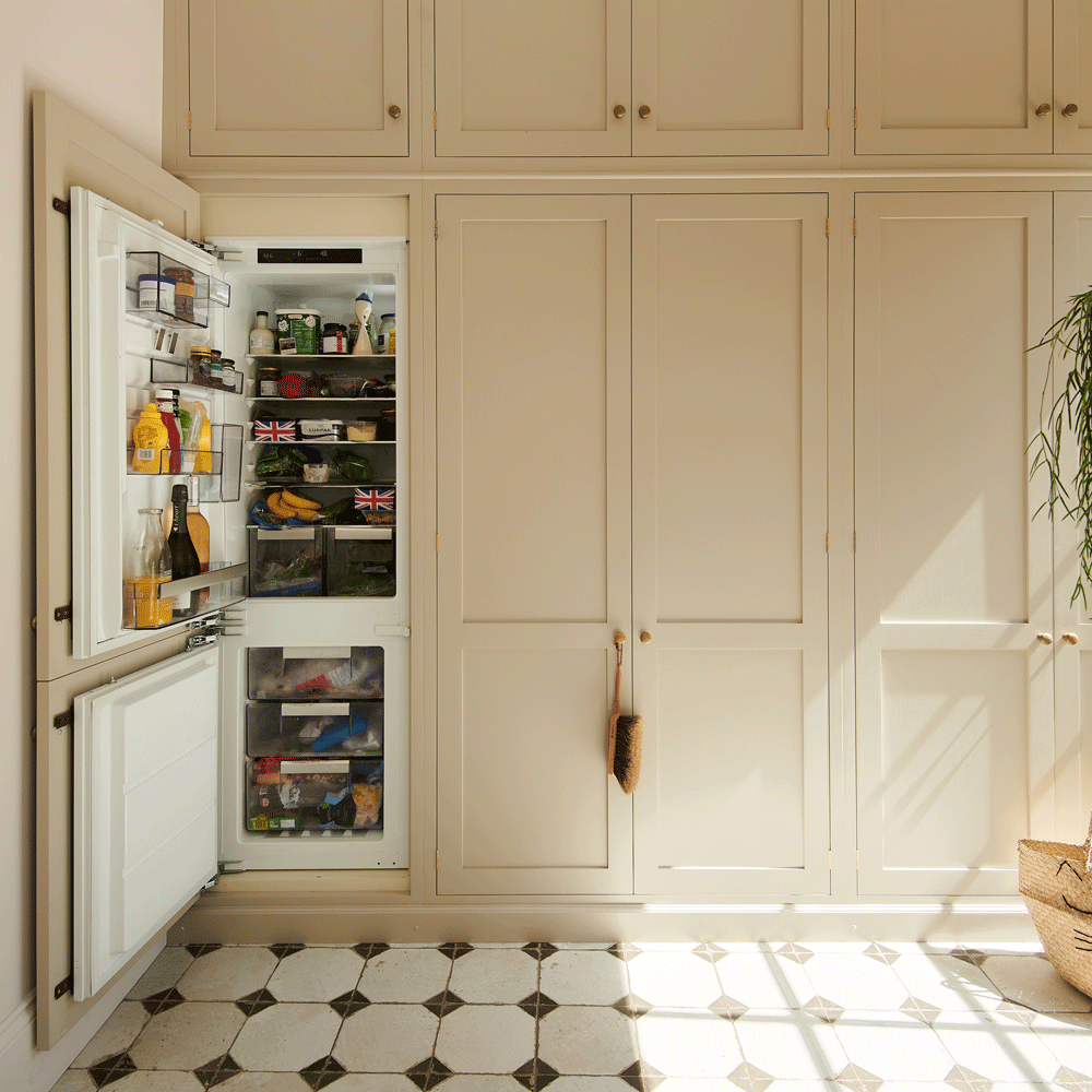 kitchen fridge with white tiles with cleaning brush