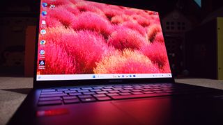 A blue ASUS Zenbook 14 OLED (UX3405) on a carpeted floor