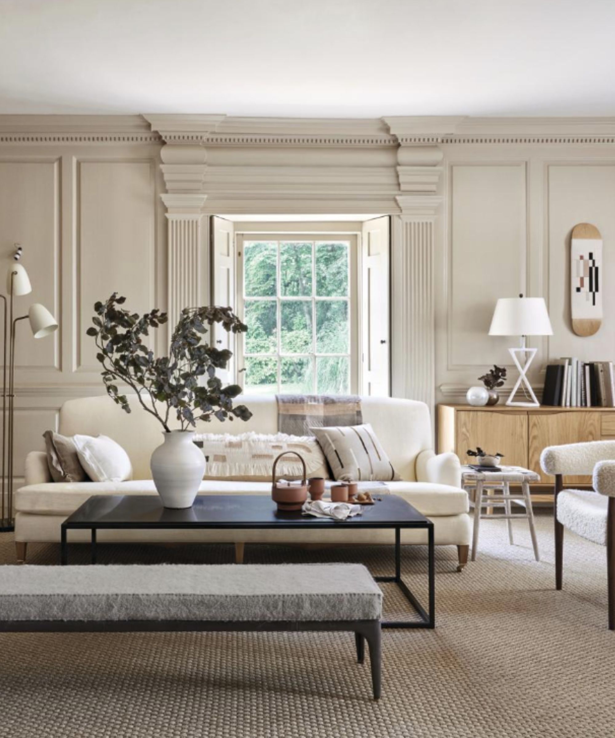 Neutral room with beige walls, ribbed wall panelling and a cream sofa