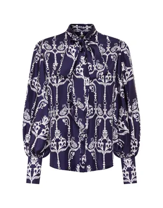 A navy pussybow blouse with a white damask print and bubble sleeves