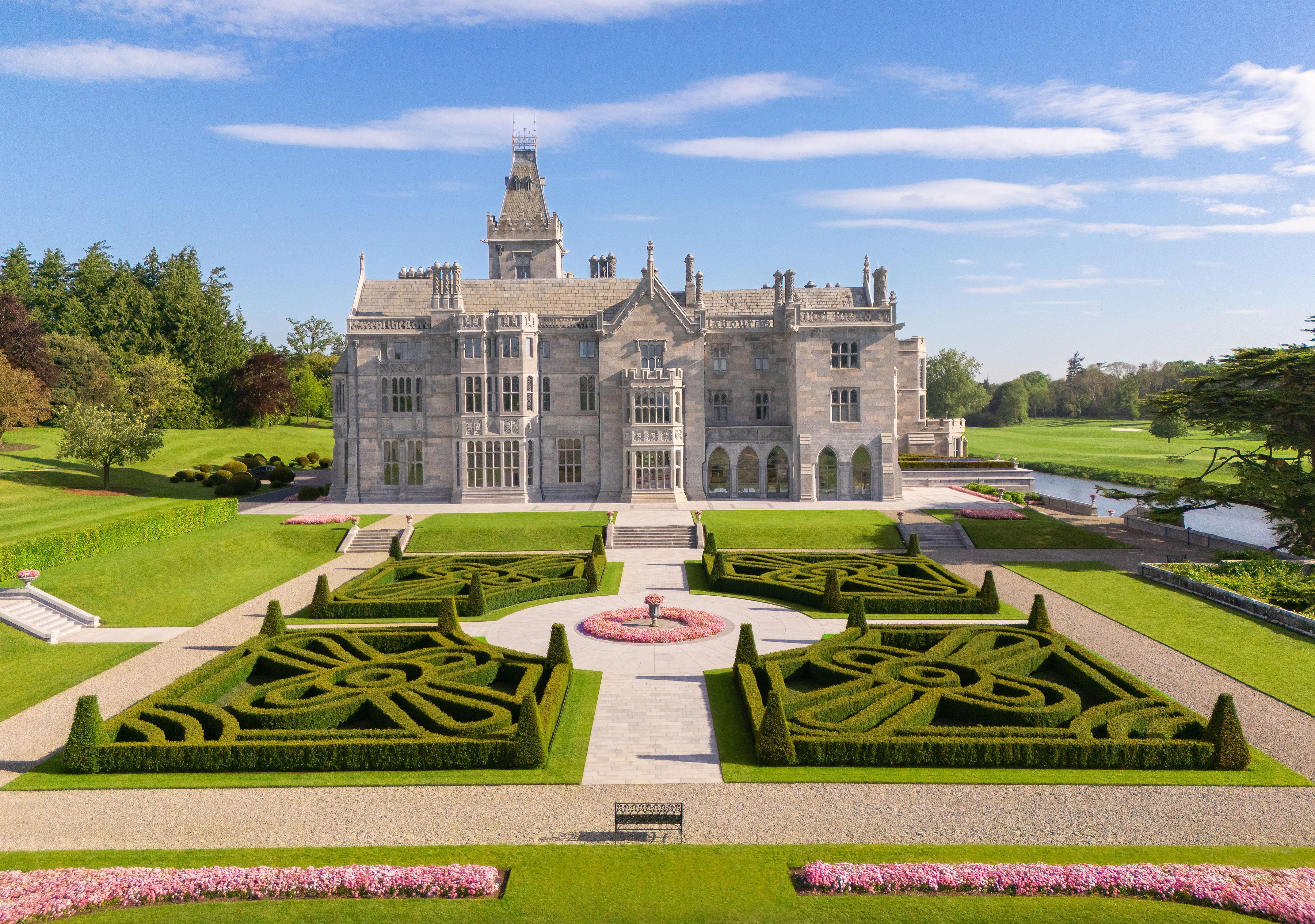 Exterior image of Adare Manor and its formal gardens