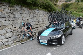 Chris Froome struggles alongside the Sky team car during stage 11 of the 2015 Vuelta a Espana.