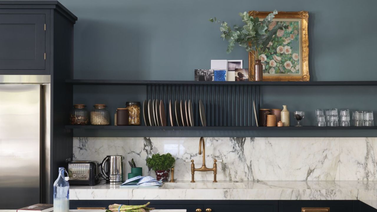 kitchen with slate blue walls, open shelving, marble countertops and backsplash