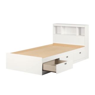 A white bed with drawers