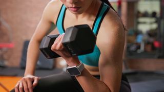 a woman doing a dumbbell bicep curl