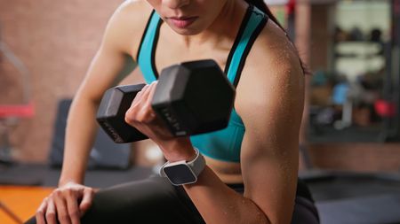 a woman doing a dumbbell bicep curl