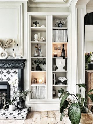A narrow cabinet constructed in the living room to hold accessories