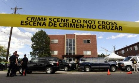 Police surround the apartment of James Holmes, the suspect in the Aurora, Colo., theater shooting. Numerous explosive devices were found in the apartment and successfully disarmed. 