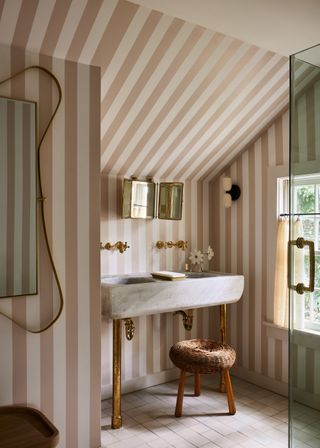 A bathroom with playful pin stripe bathroom wallpaper