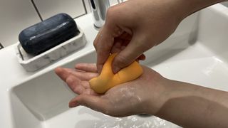 An image showing a person cleaning a Beautyblender
