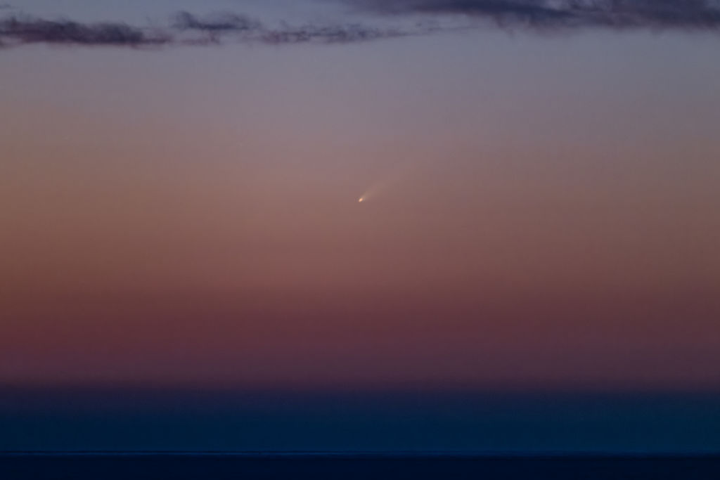 Comet C/2023 A3 (Tsuchinshan-ATLAS) appears in the sky over Molfetta, Italy, on September 28, 2024, before dawn around 6:00 AM