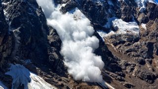 Avalanche flowing down mountain
