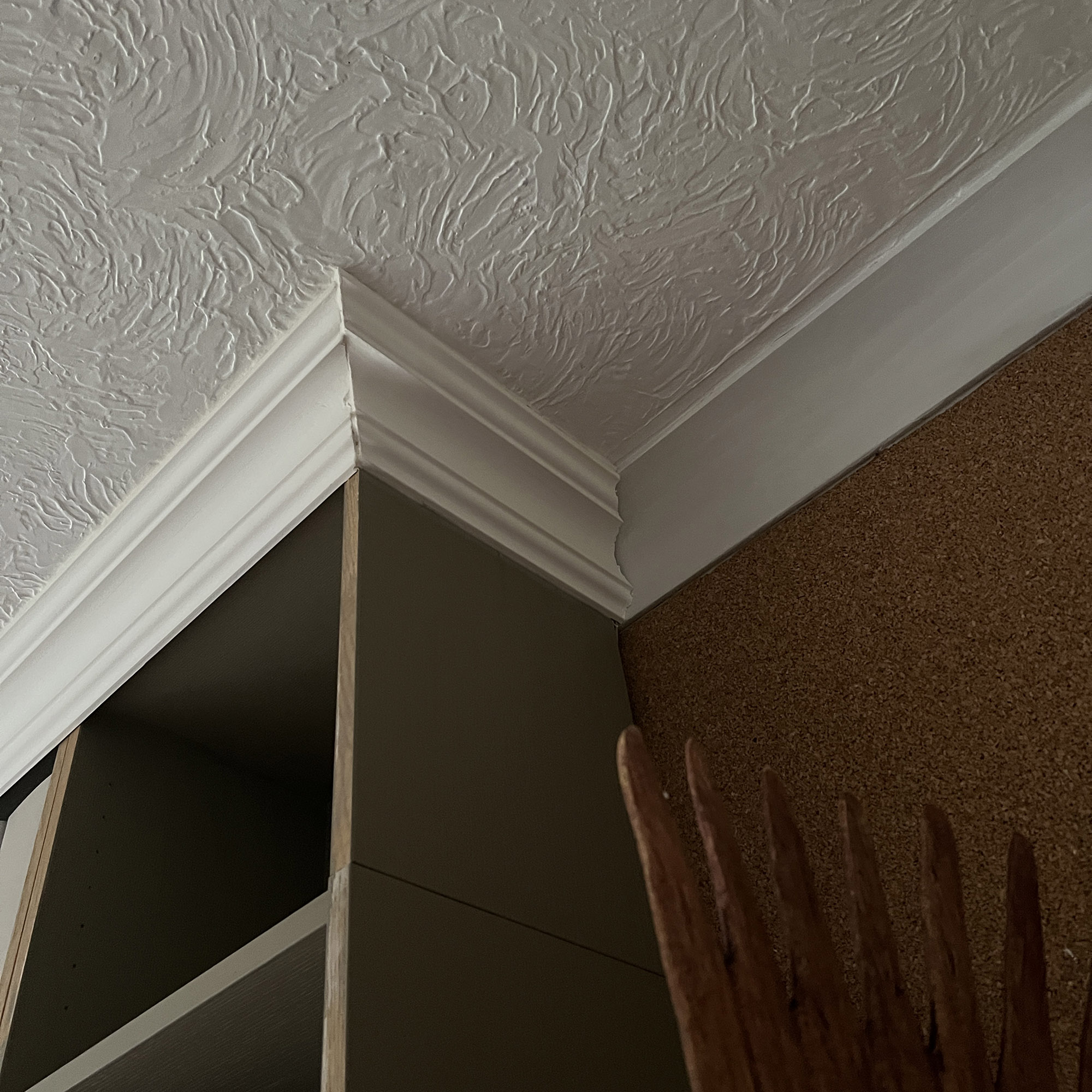 cornicing on top of a brown bookcase