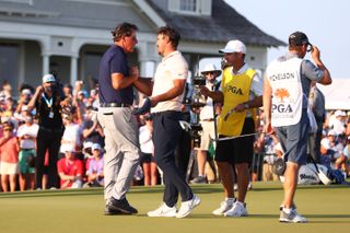 Koepka and Mickelson shake hands