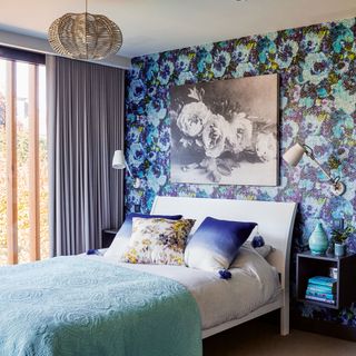 bedroom with violet colour floral wall paper and lavender colour pillows