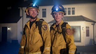 From left to right: Max Thieriot as Bode Leone looking scared and Leven Rambin as Audrey James looking concerned. They're both standing in front of a house with headlamps on.