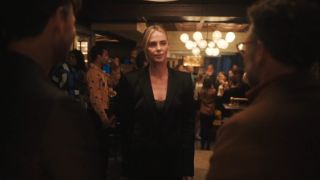 Charlize Theron glaring at Seth Rogen and Ike Barinholtz in The Studio