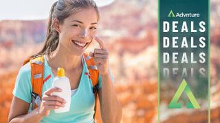 Woman applying sunscreen to her nose