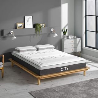 Bed with OTTY Pure Bamboo and Charcoal mattress in a gray bedroom