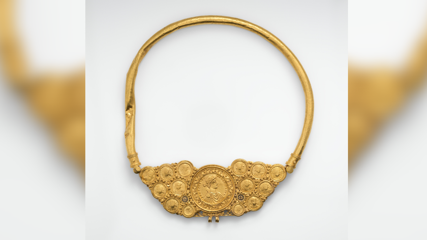 a gold necklace with 14 Byzantine gold coins at the bottom, against a white background