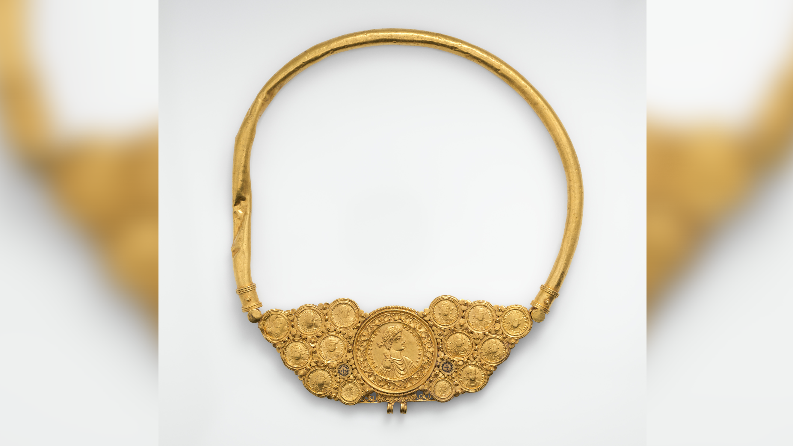 a gold necklace with 14 Byzantine gold coins at the bottom, against a white background