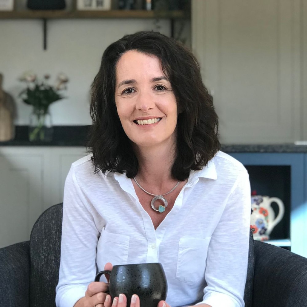 Sue Spencer professional organiser smiling and holding a mug