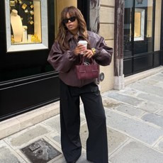 Ellie in a burgundy leather bomber jacket