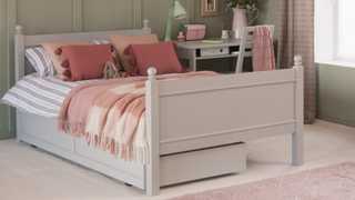 pink and green bedroom with underbed storage and desk