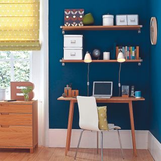 navy blue wall with wooden shelf wooden desk white chair wooden floor