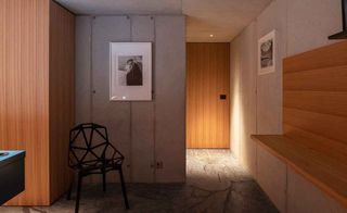 Room with one chair, wooden door, 2 frames