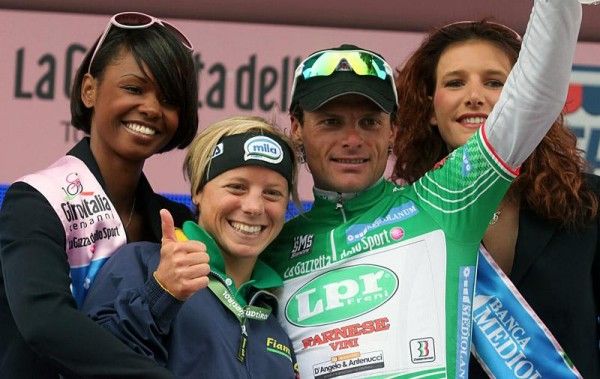 Danilo Di Luca wears the green jersey as leader of the mountains competition and gets a thumbs up from champion Italian skier Denise Karbon.