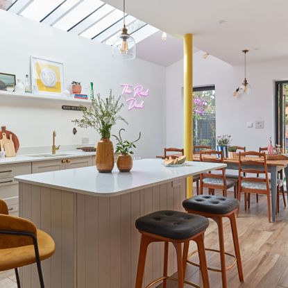 Kitchen extension with rooflights, picture windows, and an island with seating
