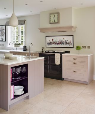 pink kitchen cabinets and island with integrated open shelving