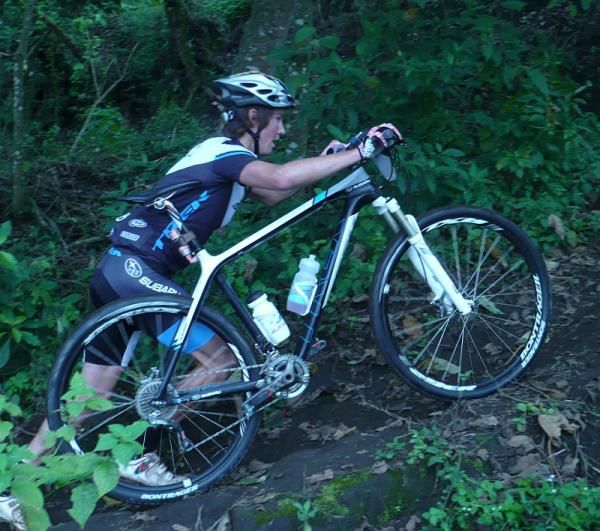Sam Schultz walks a steep off-road section