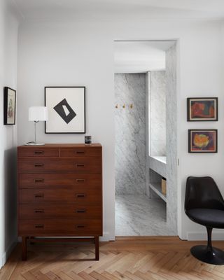 Large wooden dresser next to bathroom