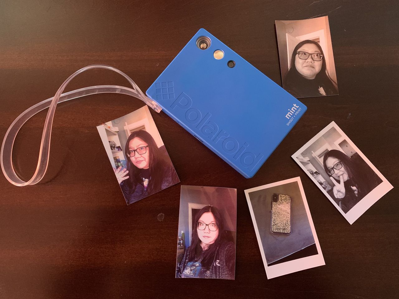 Blue Polaroid Mint Camera &amp; Printer with printed selfies of Christine Chan