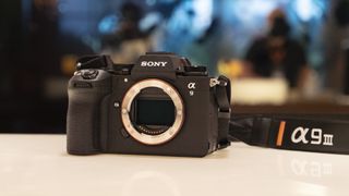 Sony A9 III no lens attached on a reflective white surface
