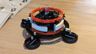 Lego technic planet earth and moon in orbit set on a white background