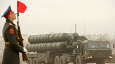 A Russian solider near a truck with missiles